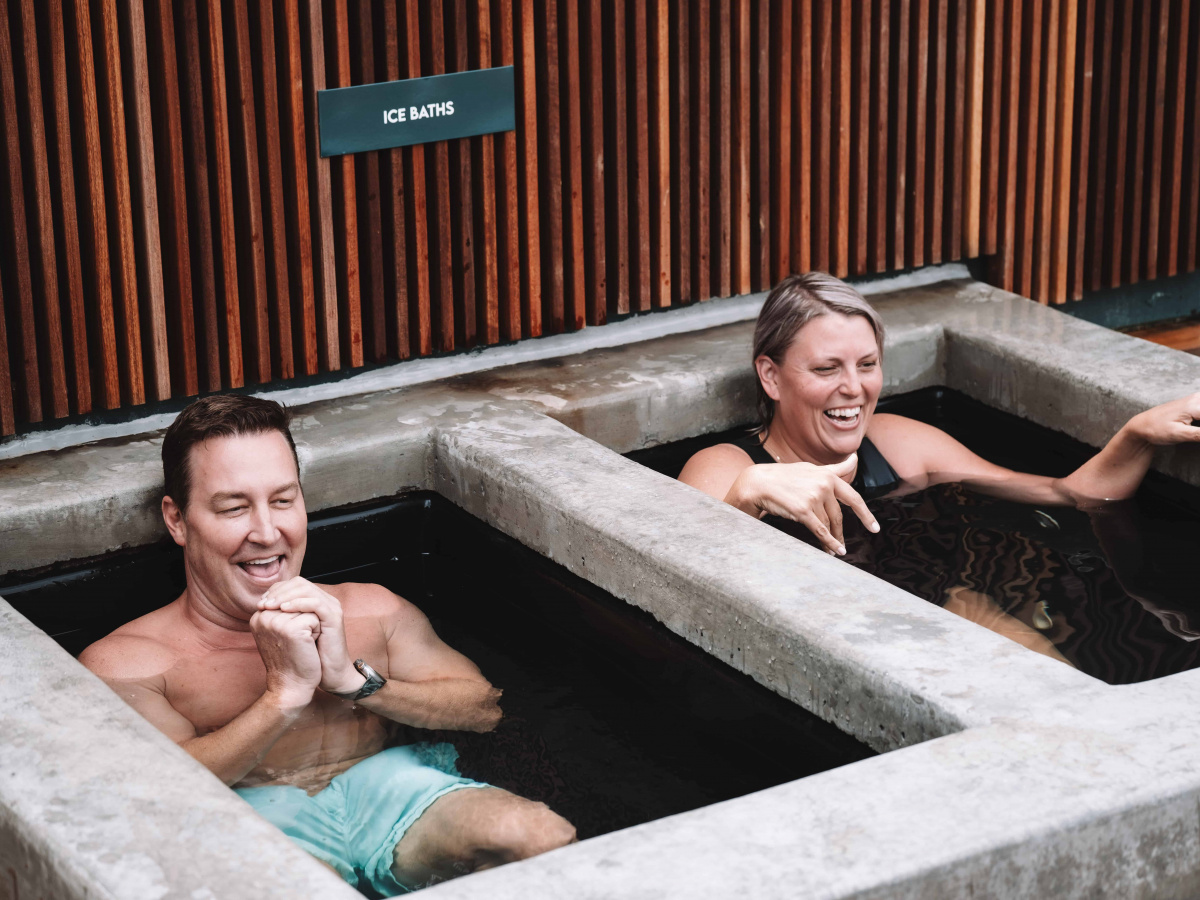 Man & woman laughing in ice bath